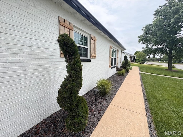 123 Clover Rd, Hannibal, MO 63401 - view of side of property featuring a lawn and brick siding