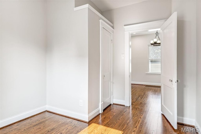7721 Weaver Ave, Maplewood, MO 63143 - hall featuring wood finished floors, baseboards, and a chandelier