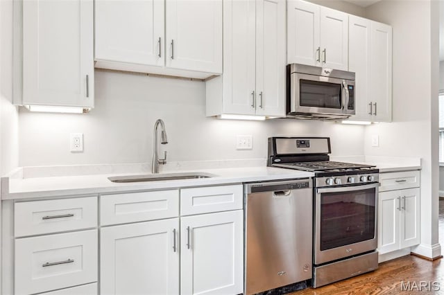 7721 Weaver Ave, Maplewood, MO 63143 - kitchen featuring appliances with stainless steel finishes, a sink, and light countertops
