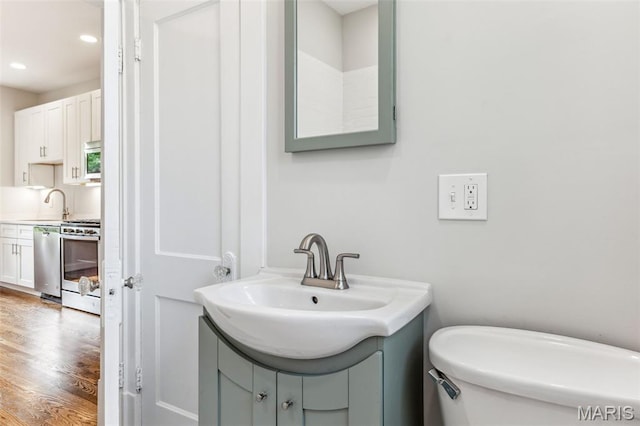 7721 Weaver Ave, Maplewood, MO 63143 - bathroom with wood finished floors, recessed lighting, and vanity