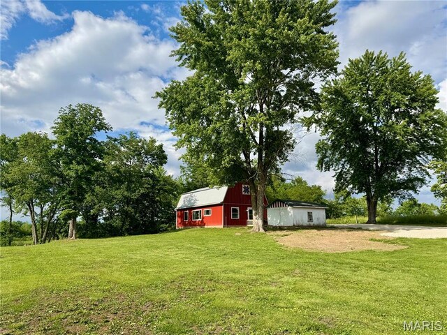 29048 State Highway V, Maywood, MO 63454 - view of grassy yard featuring a barn, an outbuilding, and dirt driveway