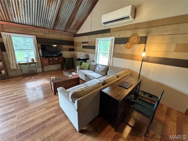 29048 State Highway V, Maywood, MO 63454 - living room with a wall mounted air conditioner, vaulted ceiling, plenty of natural light, wood finished floors, and wood walls