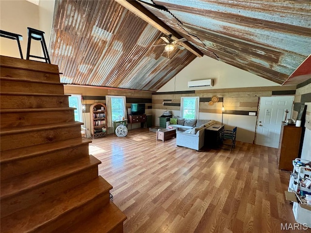 29048 State Highway V, Maywood, MO 63454 - living area with an AC wall unit, high vaulted ceiling, a ceiling fan, wood finished floors, and stairway