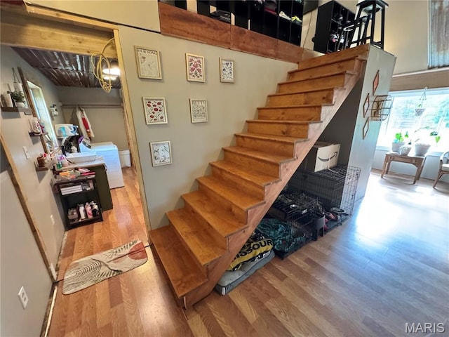 29048 State Highway V, Maywood, MO 63454 - staircase with wood finished floors, a chandelier, and washer / dryer