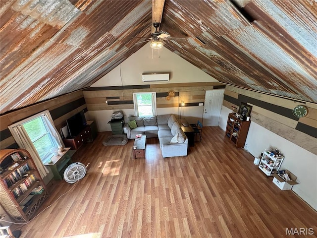 29048 State Highway V, Maywood, MO 63454 - living area featuring a wall mounted air conditioner, a ceiling fan, wood finished floors, and vaulted ceiling