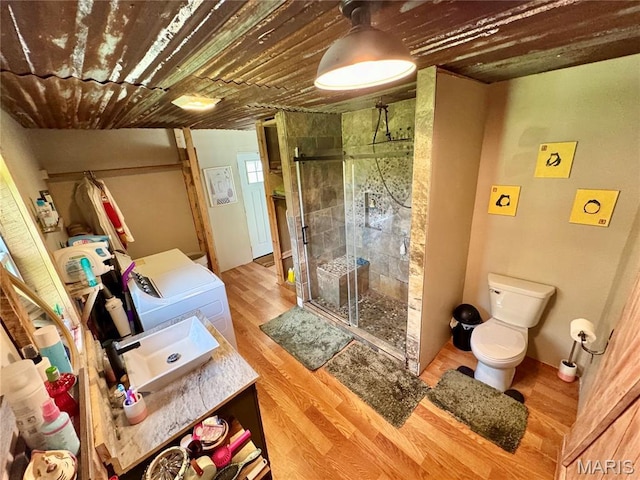 29048 State Highway V, Maywood, MO 63454 - full bath featuring separate washer and dryer, vanity, toilet, a stall shower, and wood finished floors