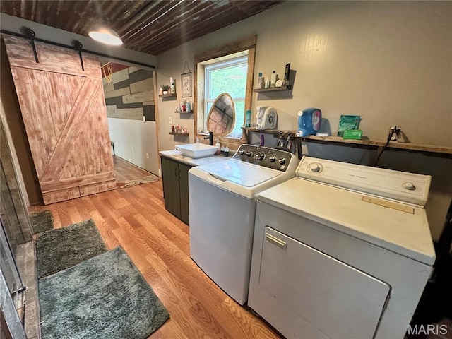 29048 State Highway V, Maywood, MO 63454 - laundry room featuring washing machine and dryer, light wood-style floors, and a barn door