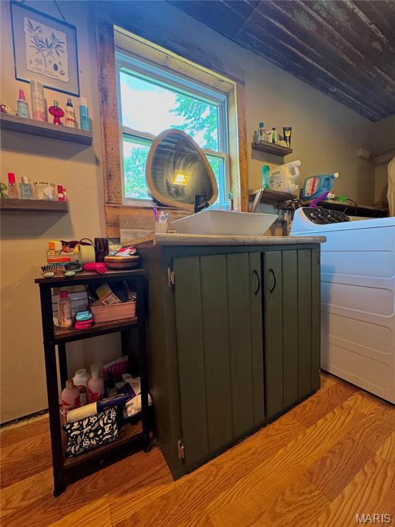 29048 State Highway V, Maywood, MO 63454 - detailed view of a sink, washer / dryer, and wood finished floors