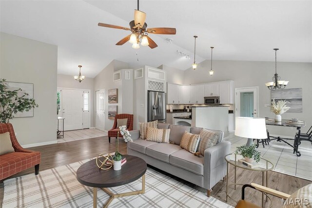 3001 Peach Blossom Ct, High Ridge, MO 63049 - living room with a chandelier, light wood-style floors, a ceiling fan, and high vaulted ceiling