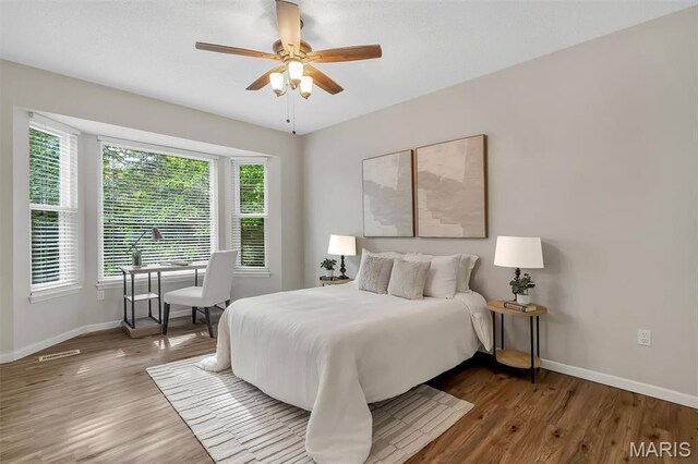 3001 Peach Blossom Ct, High Ridge, MO 63049 - bedroom featuring multiple windows, wood finished floors, and ceiling fan