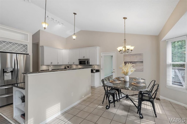 3001 Peach Blossom Ct, High Ridge, MO 63049 - kitchen featuring vaulted ceiling, stainless steel appliances, backsplash, white cabinetry, and light tile patterned floors