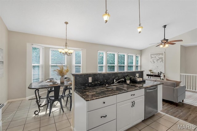 3001 Peach Blossom Ct, High Ridge, MO 63049 - kitchen with stainless steel dishwasher, ceiling fan, white cabinetry, lofted ceiling, and a chandelier