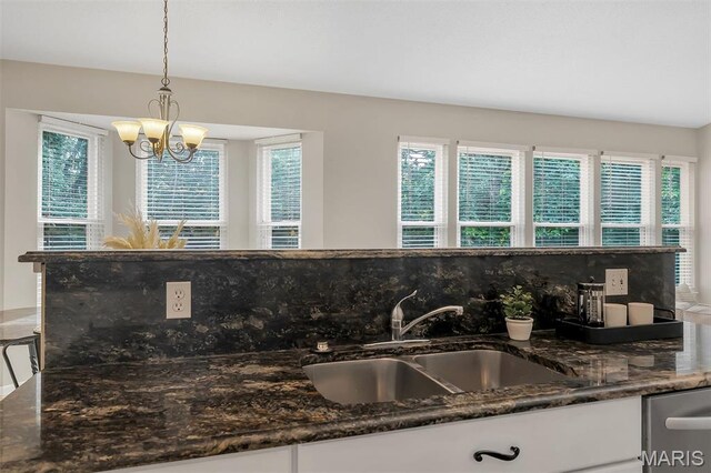 3001 Peach Blossom Ct, High Ridge, MO 63049 - kitchen view of a chandelier, white cabinetry, pendant lighting, and dark stone countertops