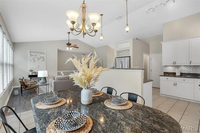 3001 Peach Blossom Ct, High Ridge, MO 63049 - dining room with vaulted ceiling, a ceiling fan, light tile patterned floors, and a chandelier
