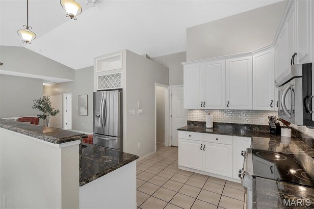 3001 Peach Blossom Ct, High Ridge, MO 63049 - kitchen with stainless steel appliances, vaulted ceiling, backsplash, white cabinetry, and light tile patterned floors