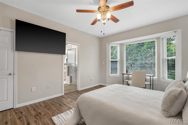 3001 Peach Blossom Ct, High Ridge, MO 63049 - bedroom featuring wood finished floors, a ceiling fan, and ensuite bath