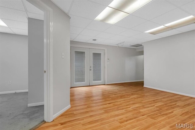 3001 Peach Blossom Ct, High Ridge, MO 63049 - unfurnished room featuring a drop ceiling, french doors, and light wood-type flooring