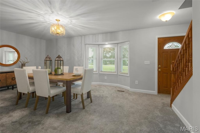 2280 Ebert Ln, Wentzville, MO 63385 - dining space featuring a chandelier, carpet flooring, and stairs