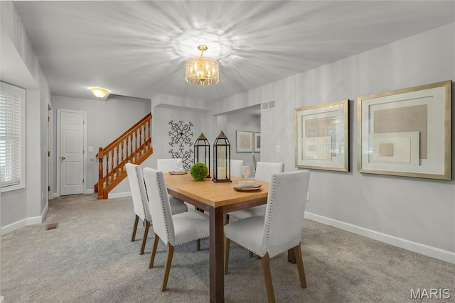 2280 Ebert Ln, Wentzville, MO 63385 - carpeted dining area with a chandelier and stairway