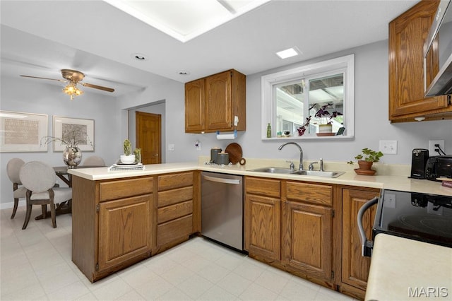 2280 Ebert Ln, Wentzville, MO 63385 - kitchen with stainless steel dishwasher, brown cabinetry, a peninsula, and light countertops