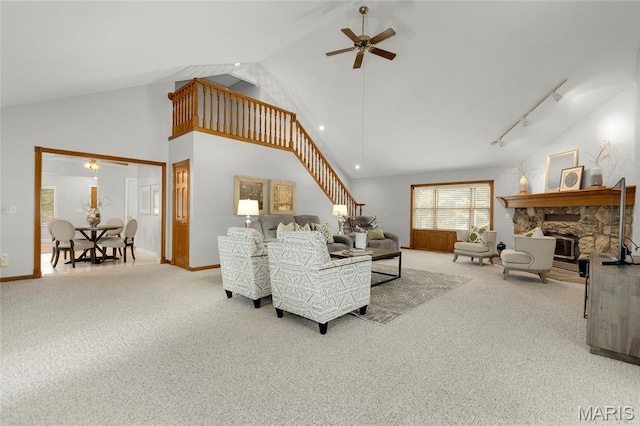 2280 Ebert Ln, Wentzville, MO 63385 - carpeted living room with ceiling fan, high vaulted ceiling, a fireplace, stairs, and track lighting