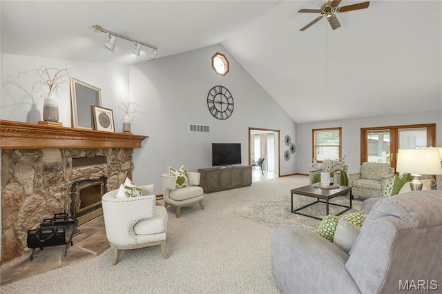 2280 Ebert Ln, Wentzville, MO 63385 - living room with carpet flooring, a ceiling fan, high vaulted ceiling, track lighting, and a stone fireplace