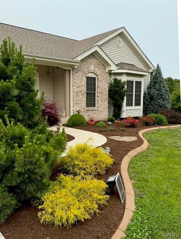 11400 Macs Cove Dr, Wright City, MO 63390 - ranch-style house with brick siding, a shingled roof, and a front yard