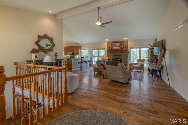 11400 Macs Cove Dr, Wright City, MO 63390 - living room featuring a ceiling fan, beam ceiling, a fireplace, wood finished floors, and high vaulted ceiling