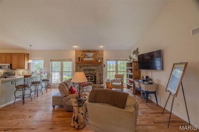 11400 Macs Cove Dr, Wright City, MO 63390 - living area with light wood-style floors, a fireplace, and baseboards