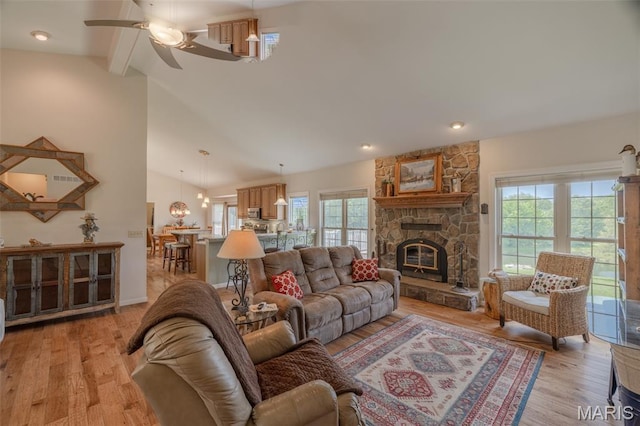 11400 Macs Cove Dr, Wright City, MO 63390 - living area featuring light wood-style flooring, plenty of natural light, a ceiling fan, and a stone fireplace