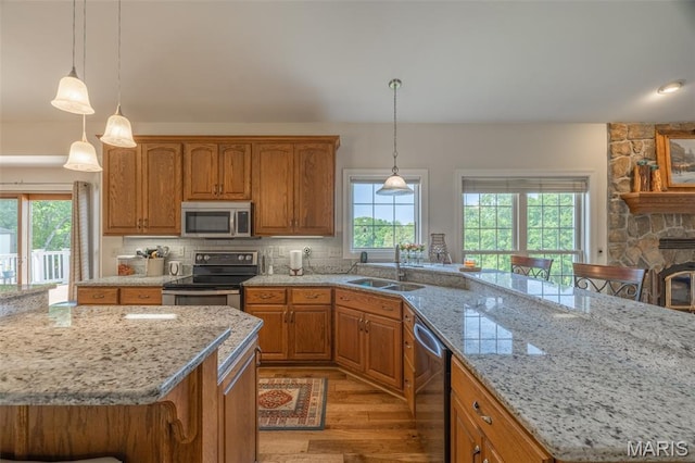 11400 Macs Cove Dr, Wright City, MO 63390 - kitchen with stainless steel appliances, plenty of natural light, light wood-type flooring, and a sink