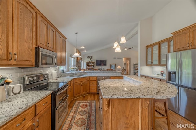 11400 Macs Cove Dr, Wright City, MO 63390 - kitchen featuring appliances with stainless steel finishes, light wood-type flooring, a peninsula, backsplash, and glass insert cabinets