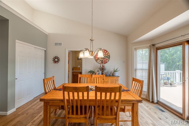 11400 Macs Cove Dr, Wright City, MO 63390 - dining area with light wood-style flooring, lofted ceiling, a chandelier, and baseboards