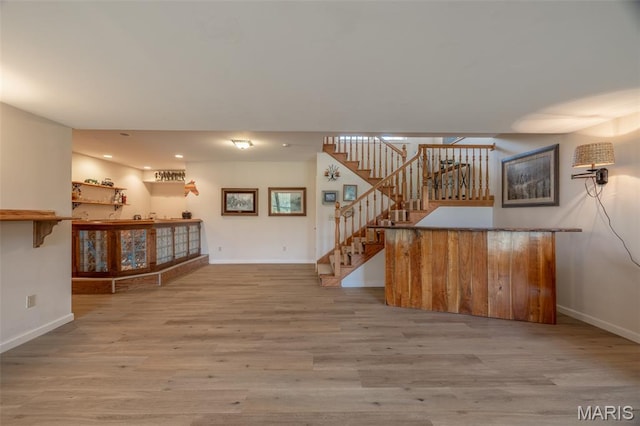 11400 Macs Cove Dr, Wright City, MO 63390 - unfurnished living room with bar, stairway, baseboards, and recessed lighting