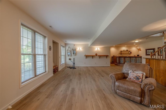 11400 Macs Cove Dr, Wright City, MO 63390 - living area with light wood-style floors, baseboards, and stairway