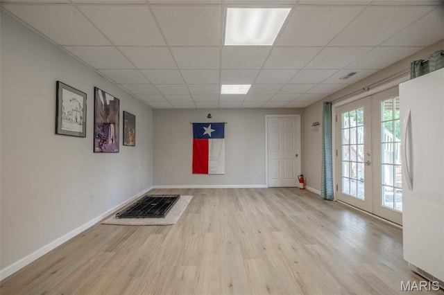 11400 Macs Cove Dr, Wright City, MO 63390 - empty room with wood finished floors, french doors, baseboards, and a paneled ceiling
