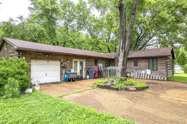 10049 Chateau Rd, Sullivan, MO 63080 - view of front facade featuring driveway, an attached garage, and log siding
