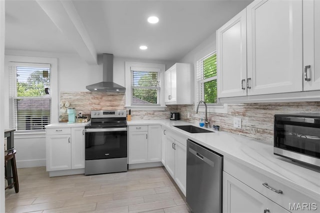 1210 Perryville Rd, Cape Girardeau, MO 63701 - kitchen featuring wall chimney range hood, stainless steel appliances, a sink, recessed lighting, and tasteful backsplash