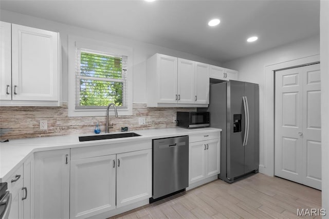 1210 Perryville Rd, Cape Girardeau, MO 63701 - kitchen featuring stainless steel appliances, a sink, tasteful backsplash, white cabinetry, and recessed lighting