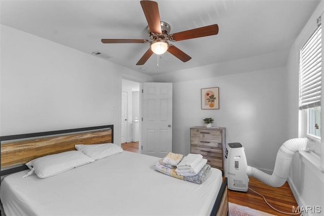1210 Perryville Rd, Cape Girardeau, MO 63701 - bedroom featuring wood finished floors, multiple windows, a ceiling fan, and baseboards