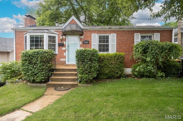 7330 Lansdowne Ave, Saint Louis, MO 63119 - view of front facade featuring a front yard, brick siding, and a chimney