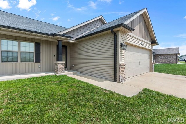 192 Fraser Rdg, Jackson, MO 63755 - view of front of home featuring a garage, a front yard, driveway, and a shingled roof
