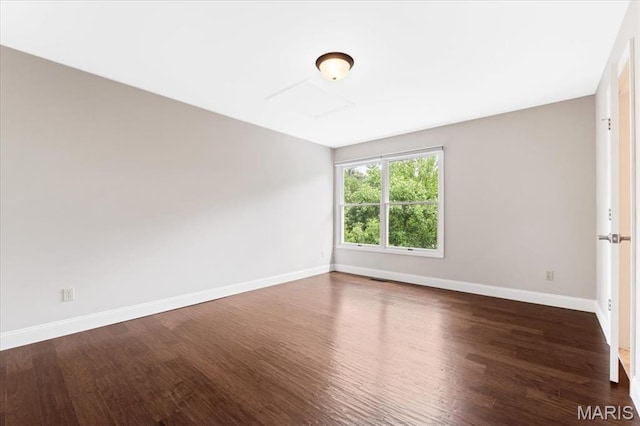 1525 Honey Locust Ct, Wildwood, MO 63005 - spare room featuring dark wood-style flooring and baseboards