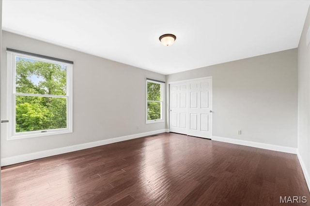 1525 Honey Locust Ct, Wildwood, MO 63005 - unfurnished bedroom featuring multiple windows and wood finished floors