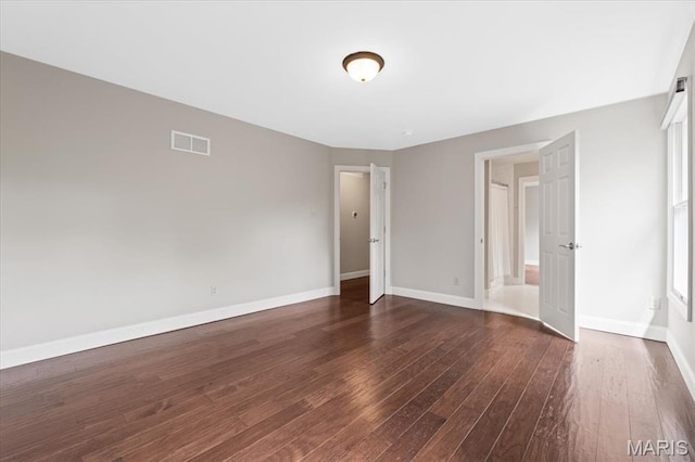 1525 Honey Locust Ct, Wildwood, MO 63005 - unfurnished bedroom with dark wood-style floors and baseboards