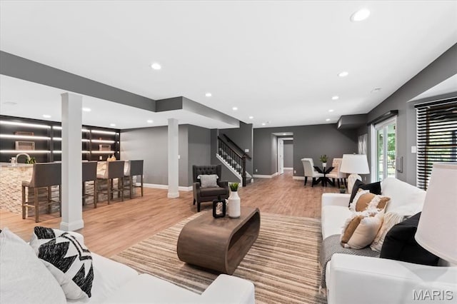 1525 Honey Locust Ct, Wildwood, MO 63005 - living room with stairs, wood finished floors, recessed lighting, ornate columns, and bar