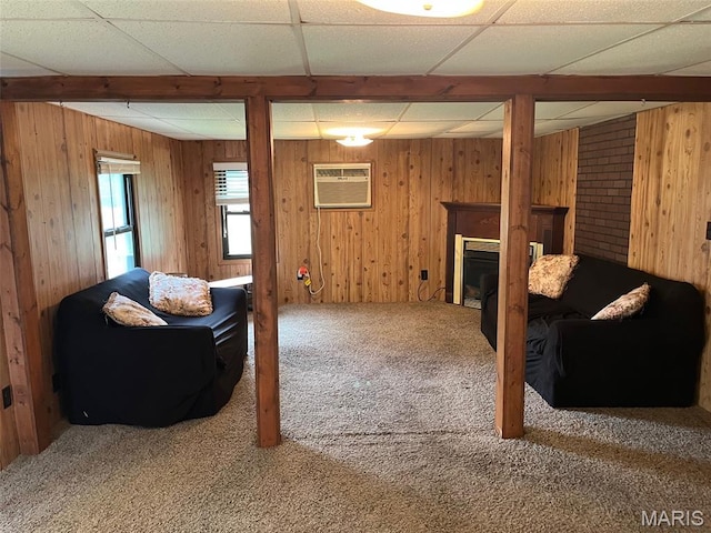11142 E State Highway 47, Cadet, MO 63630 - carpeted living area with a wall mounted AC, a paneled ceiling, wood walls, and a fireplace
