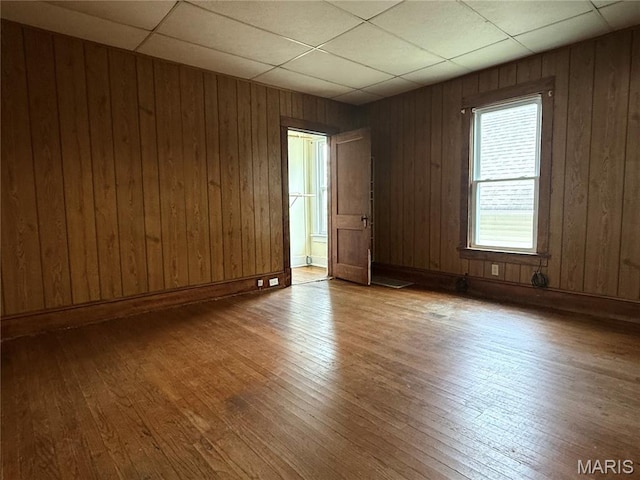 417 N Section St, Hannibal, MO 63401 - unfurnished room featuring wood-type flooring, a paneled ceiling, and wood walls