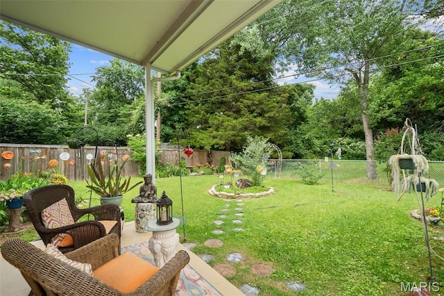 2604 Jonathan Dr, Mehlville, MO 63125 - fenced backyard with view of scattered trees and a patio