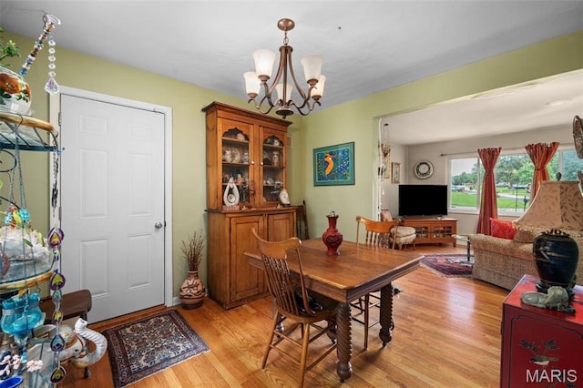 2604 Jonathan Dr, Mehlville, MO 63125 - dining room featuring a chandelier and light wood-style flooring